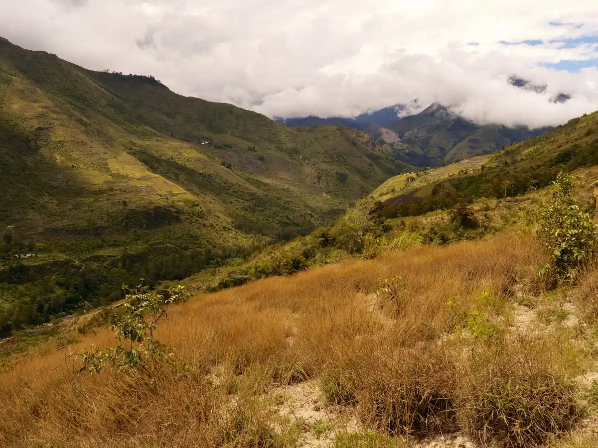Grassy slopes and cloud above the Baliem Valley
