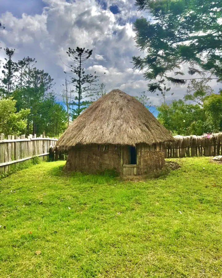 A single honai under a dramatic sky near Wamena