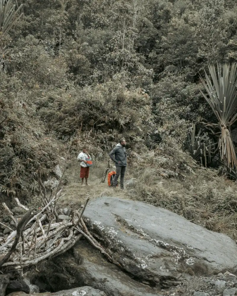 Two trekkers on a rocky highland trail in Papua